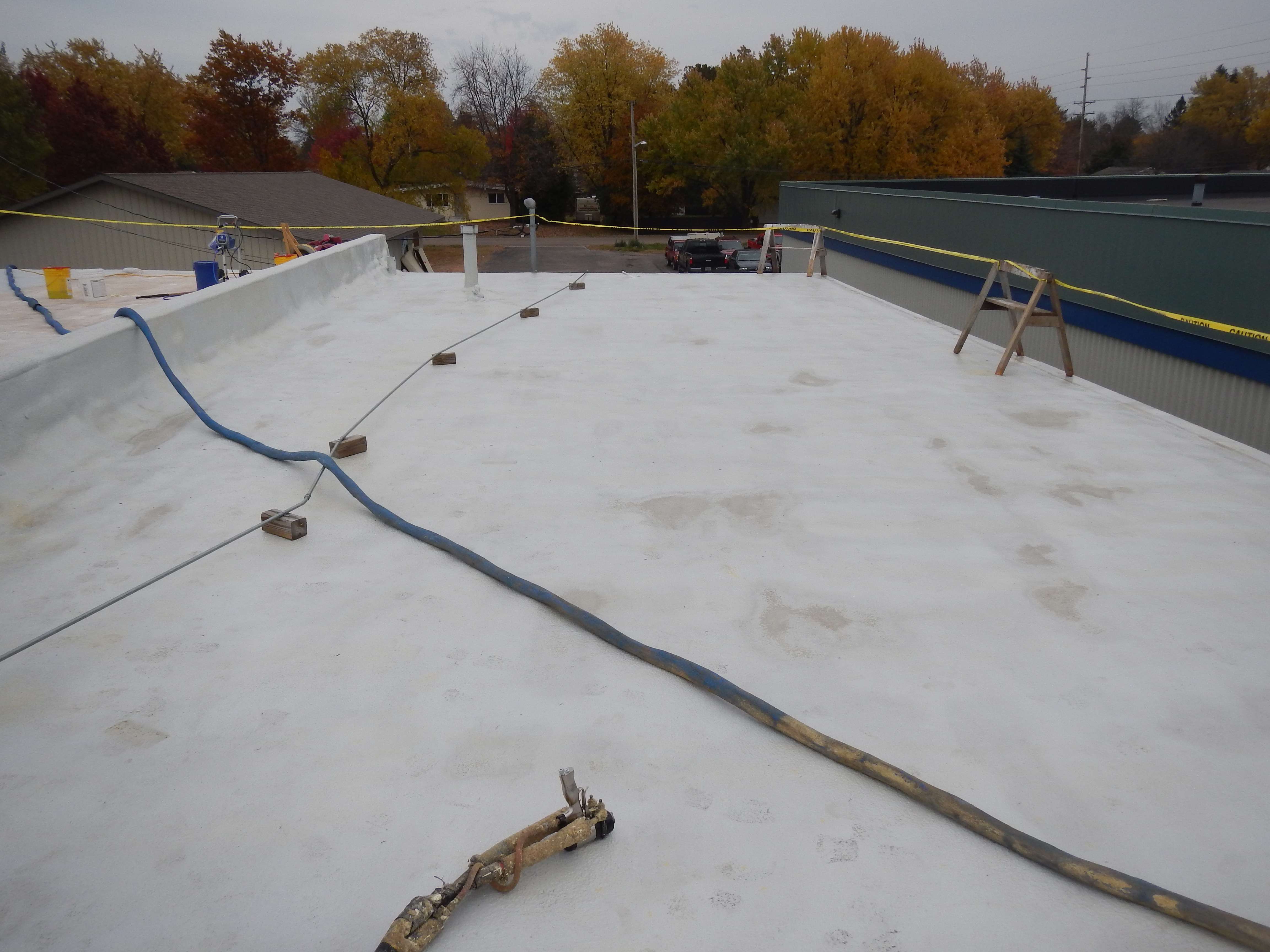Roof restoration coating applied over an existing membrane